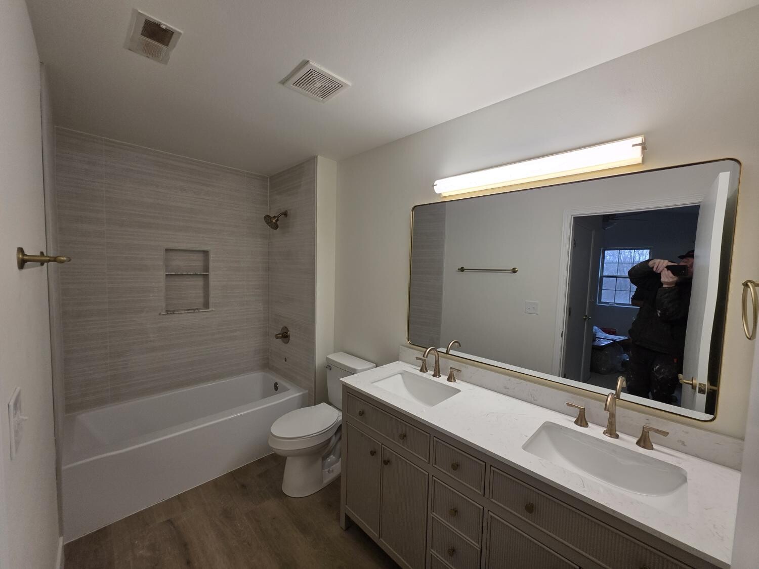 Family bath with double vanity and linear tile tub