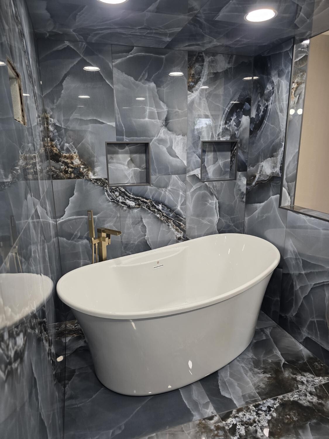 Freestanding tub in stone surround