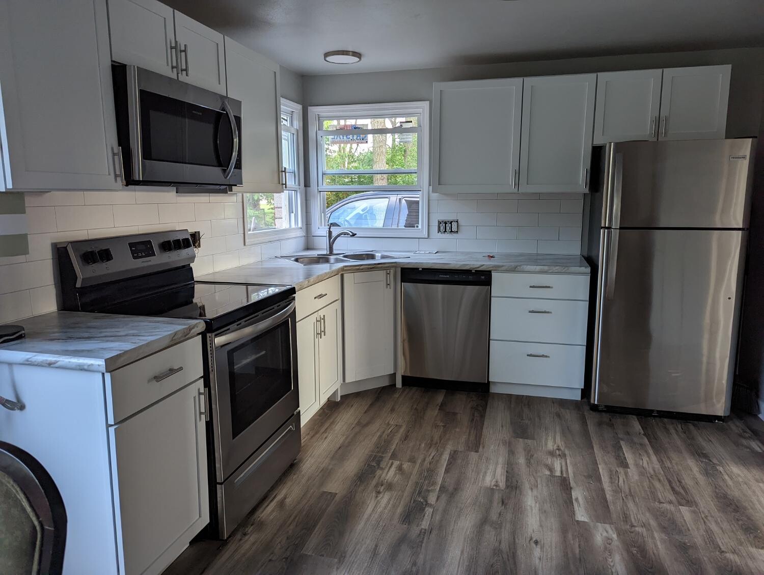 White shaker kitchen with stainless appliances